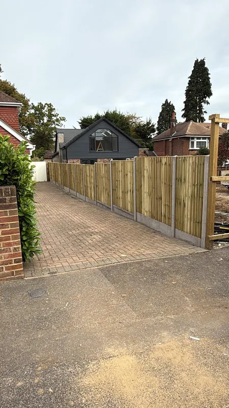Block paved pathway between fence panels leading to the rear of the property, Kent