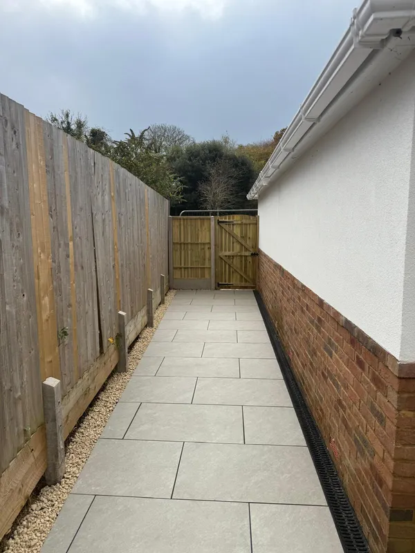 Light porcelain paving running the length of the side passage, Kent