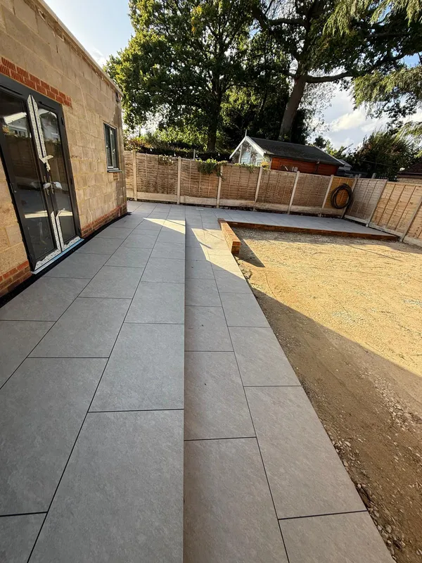 Grey porcelain slab pathway leading away from patio doors, Kent