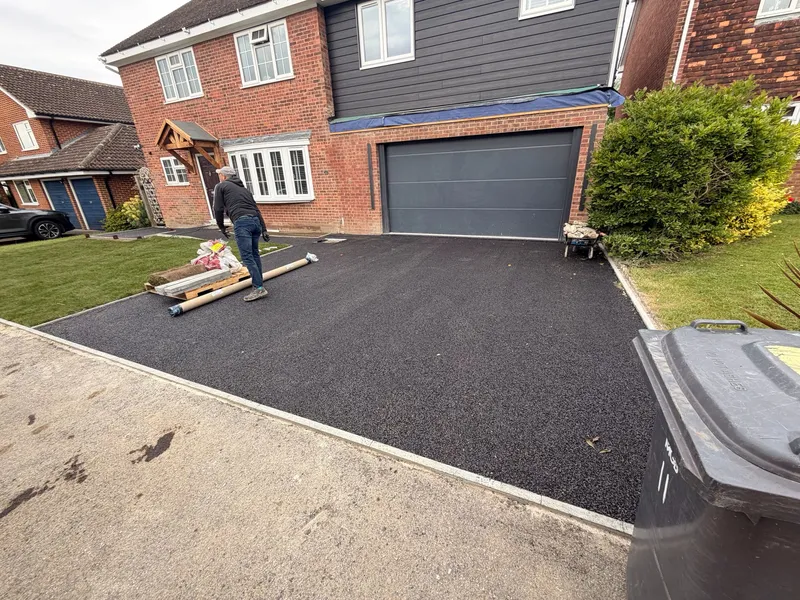 Fresh tarmac base being laid as the foundation for a resin bound driveway in Kent