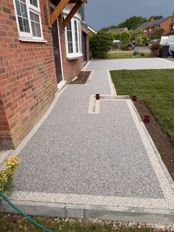 Resin bound pathway with block paved edging running beside the house, Kent
