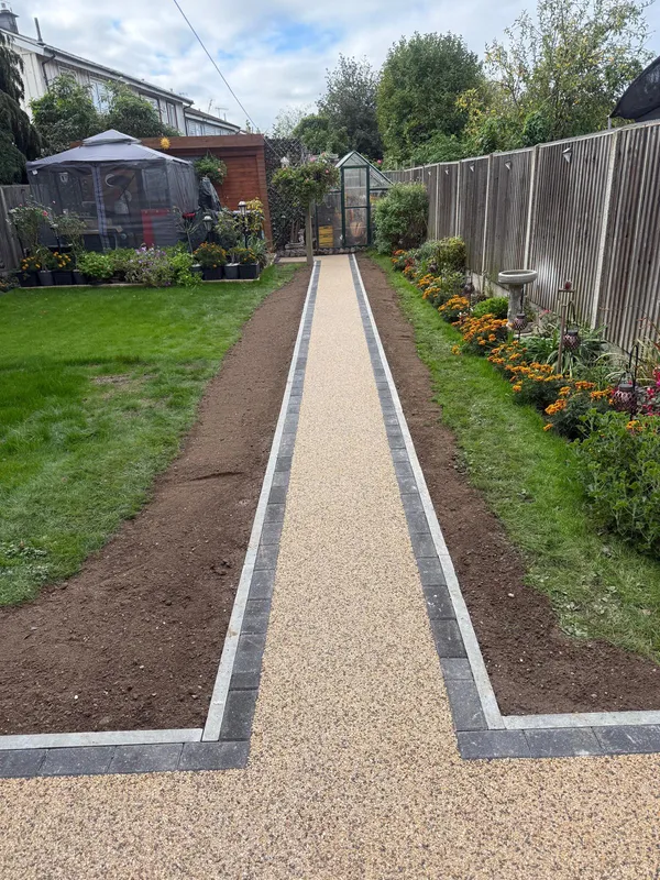 Completed resin bound path with kerb edging leading down a Kent back garden